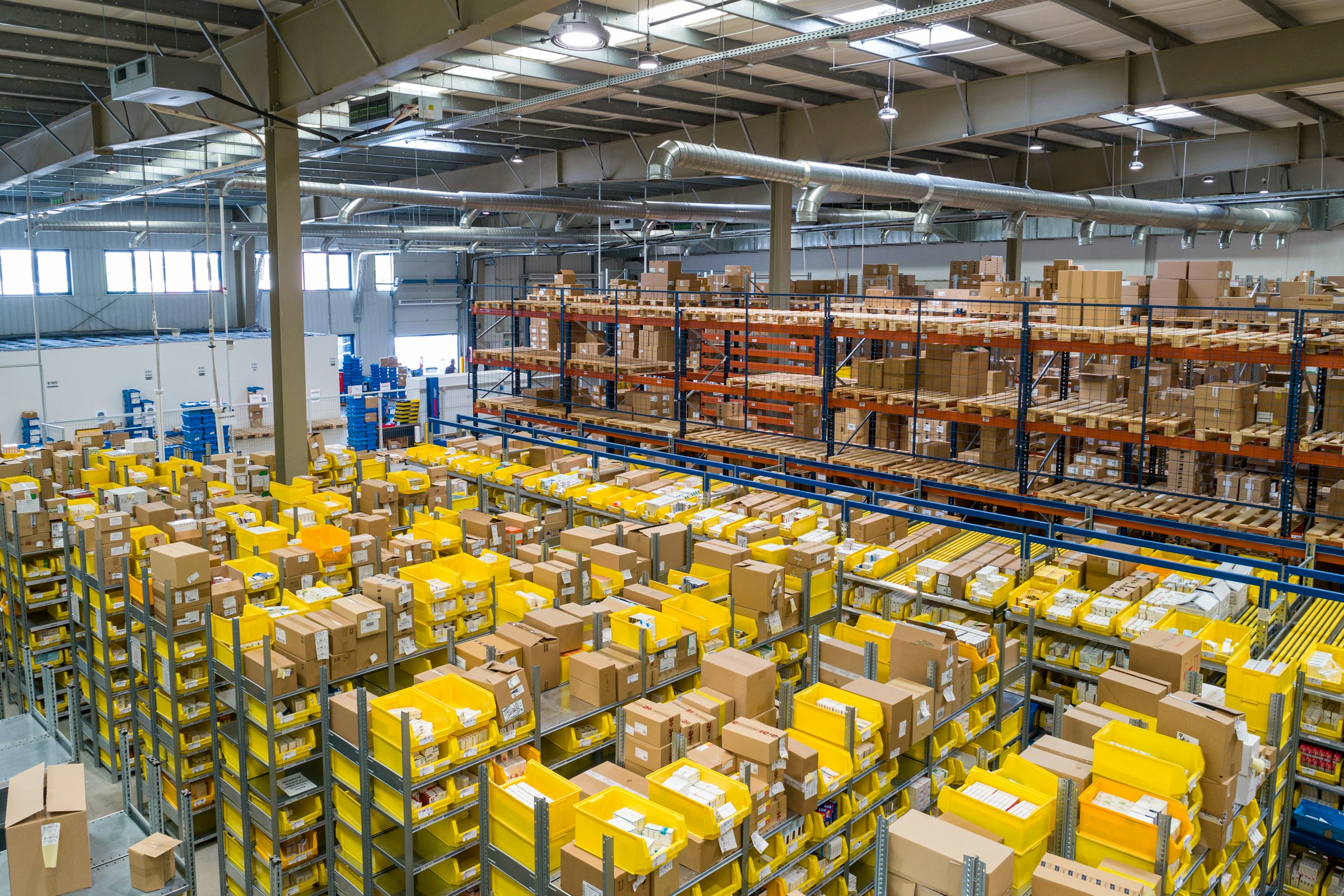 Warehouse and logistics facility with industrial racking and overhead lighting