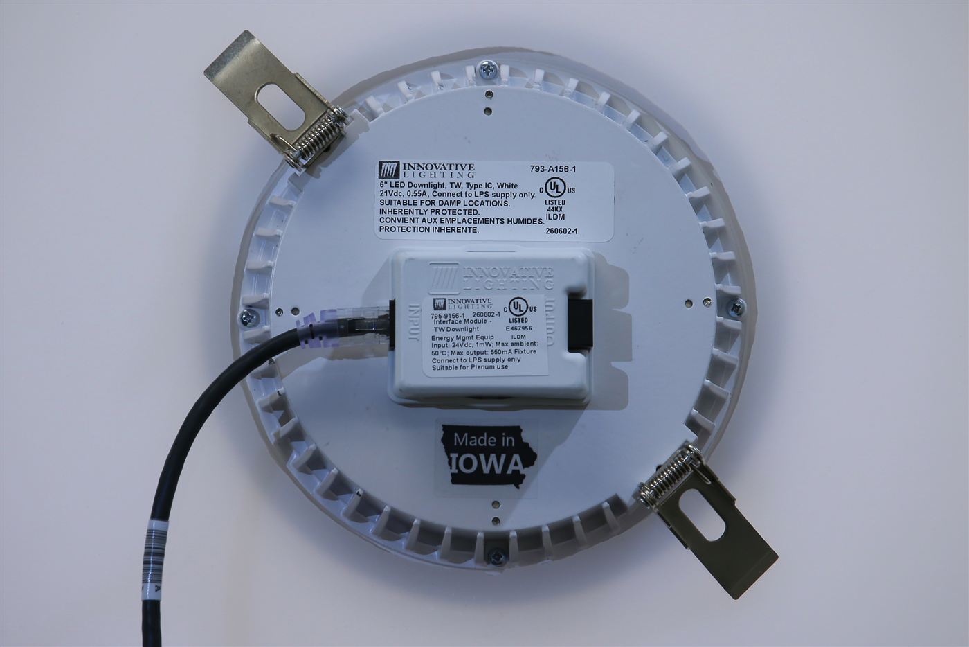 Back of GENISYS PoE 6-inch downlight with RJ45 cable, interface module, and Made in Iowa label