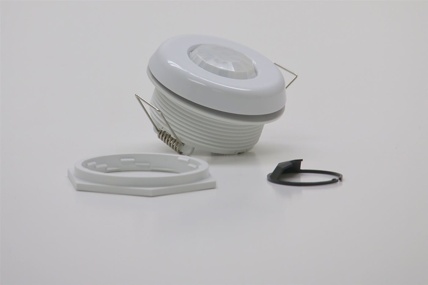 GENISYS PoE occupancy sensor with mounting nut, spring clips, and install hardware