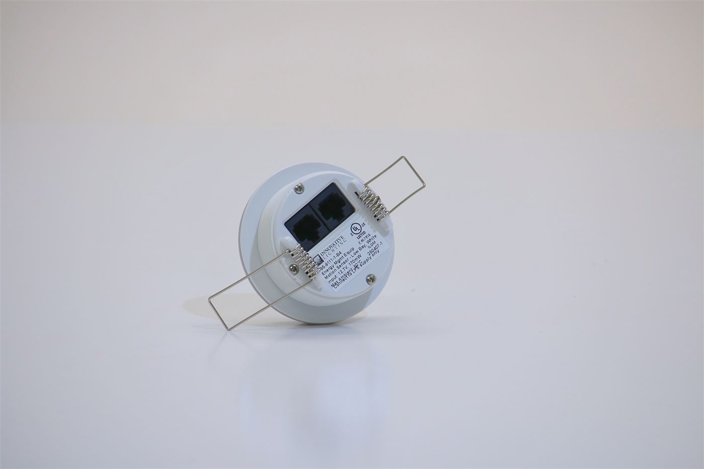 Back of GENISYS PoE occupancy sensor showing dual RJ45 ports and UL listing label