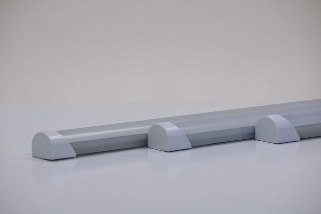 GENISYS SmoothLite PoE linear fixtures showing silver housing, frosted diffuser, and white dome end caps