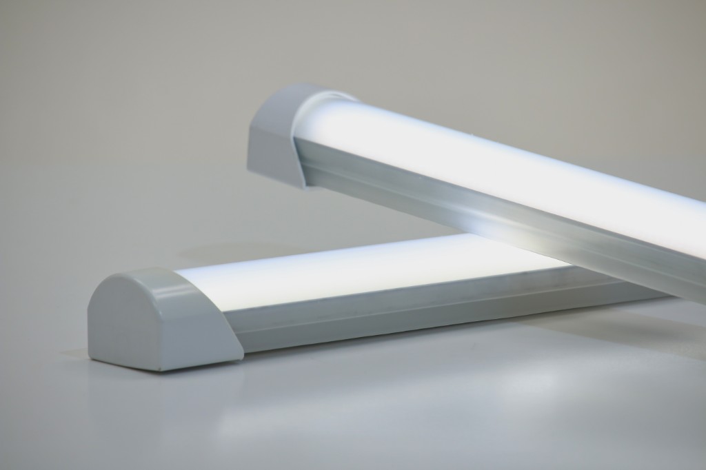 Two GENISYS SmoothLite PoE lighting fixtures illuminated and stacked at an angle