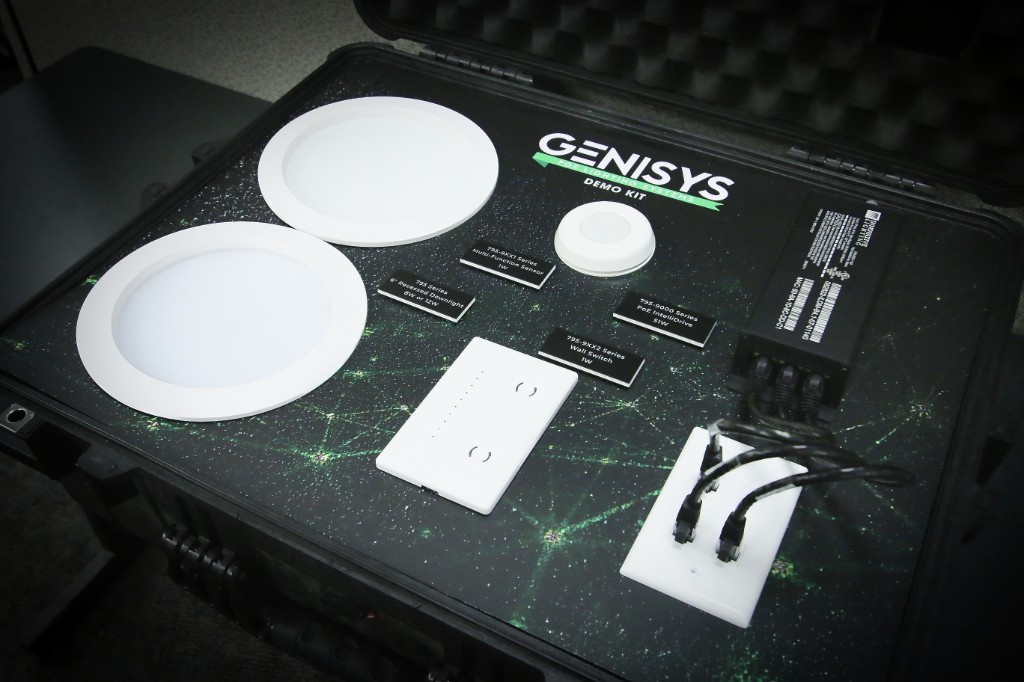 GENISYS PoE lighting demo kit with two 6-inch downlights, occupancy sensor, wall switch, and IntelliDrive labeled for a live demo