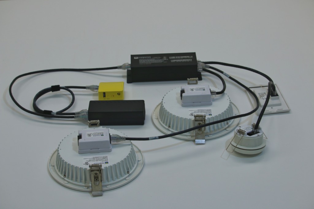 Cabled GENISYS PoE lighting starter kit showing rear fixture connections and IntelliDrive ports
