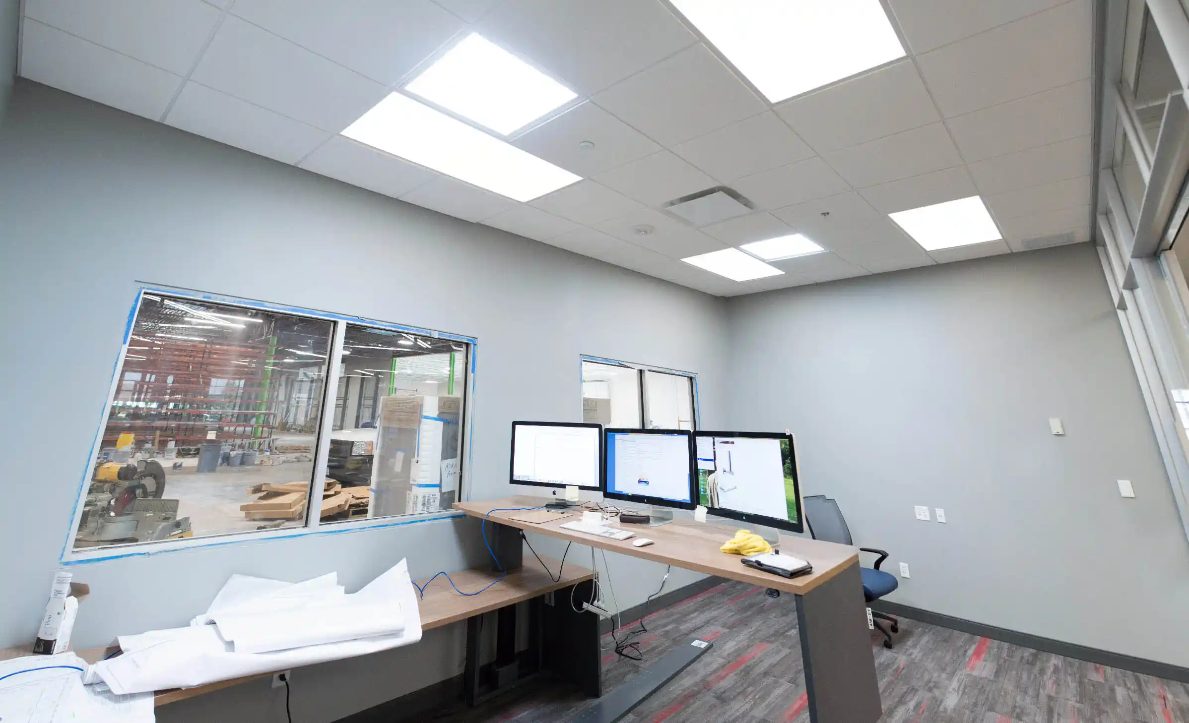 GENISYS PoE Leaf troffer in a construction showcase with green network graphics