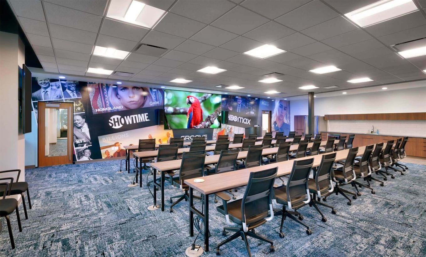 Groove training and presentation room with GENISYS PoE lighting and branded media wall