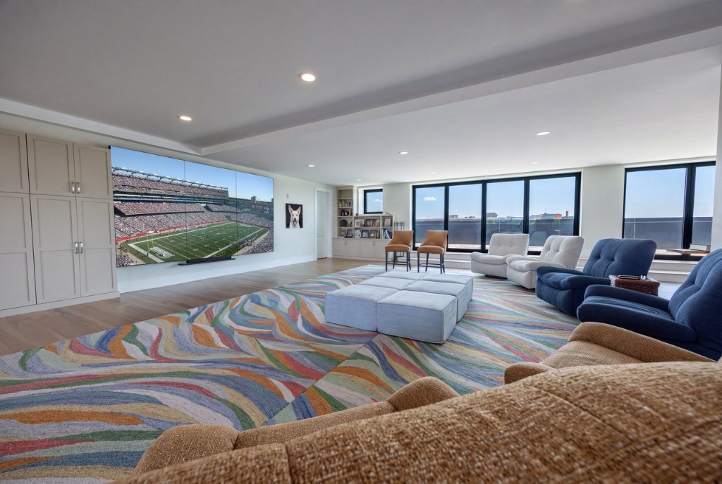 Portsmouth penthouse media room with GENISYS PoE downlights and a wall-sized display