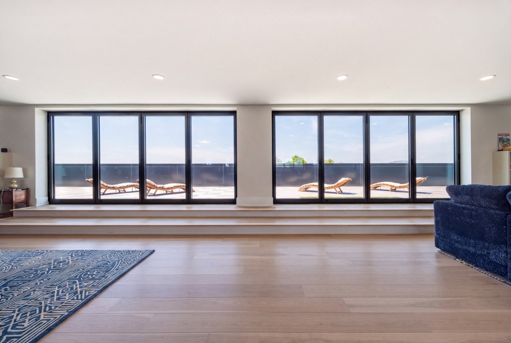 Portsmouth penthouse terrace windows with GENISYS PoE downlights over lounge chairs