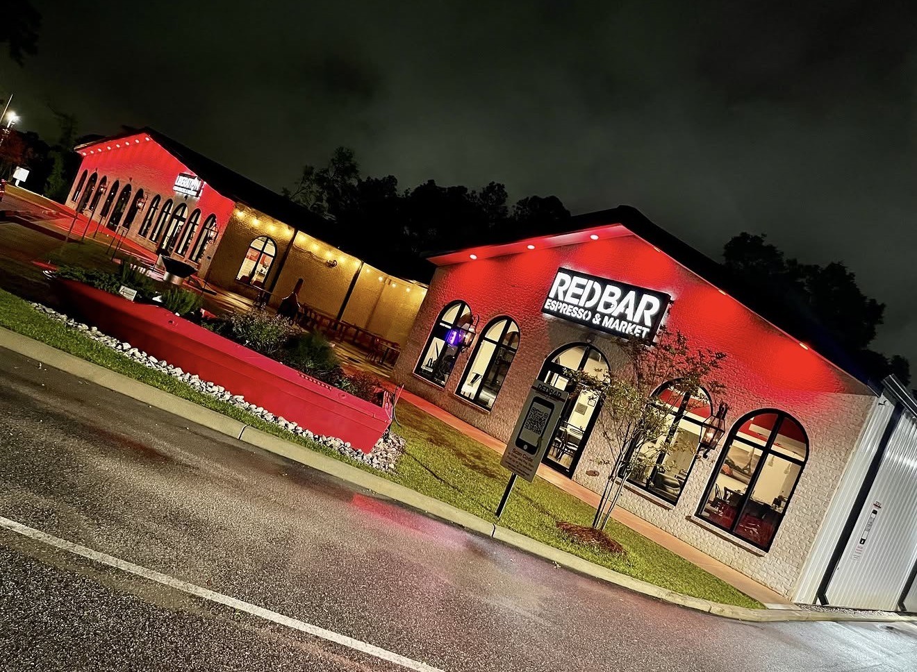 REDBAR Espresso & Market exterior at night washed in GENISYS RGB downlight color