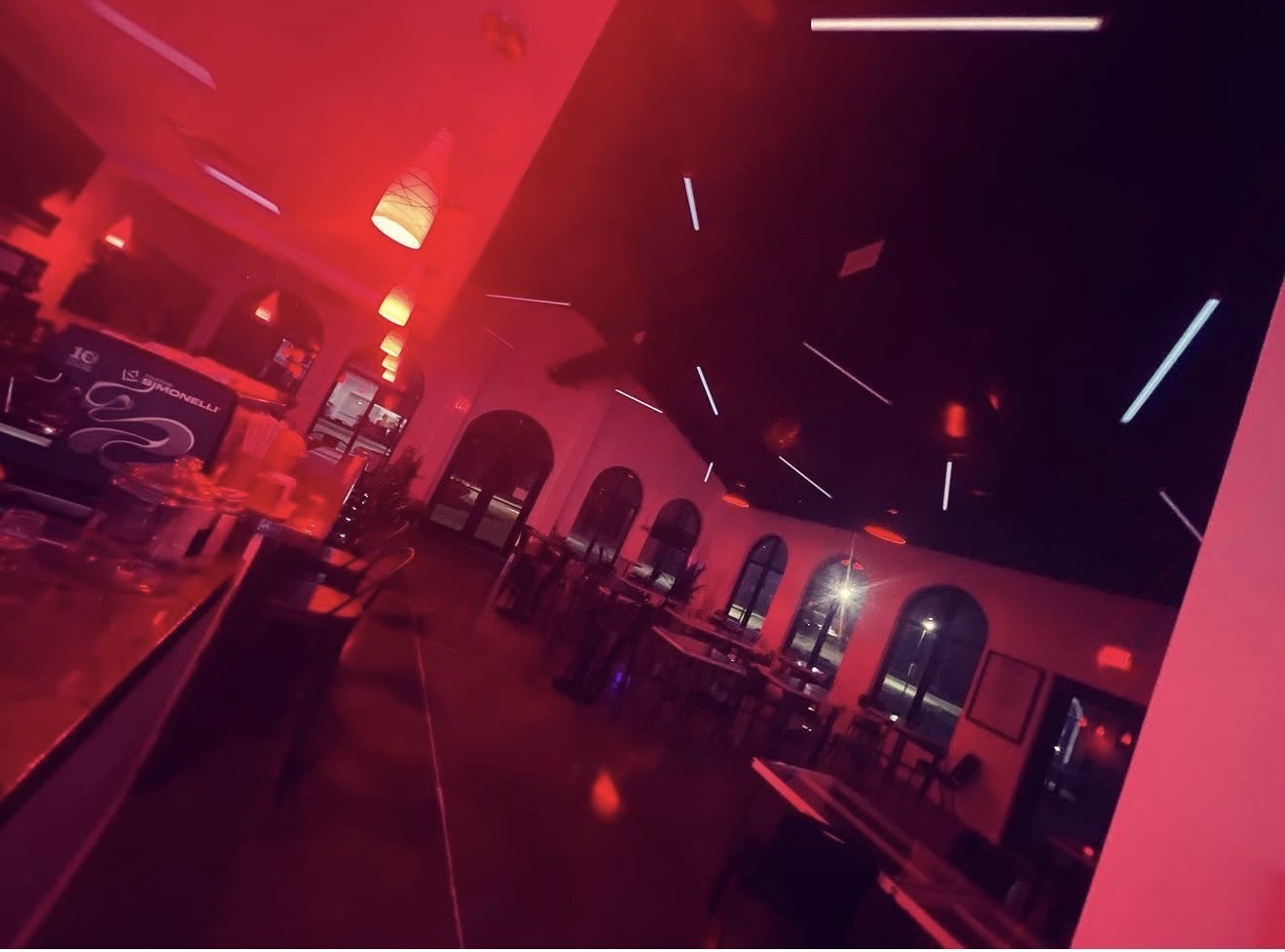 REDBAR dining room at night with red ambient GENISYS PoE lighting and SmoothLite ceiling lines