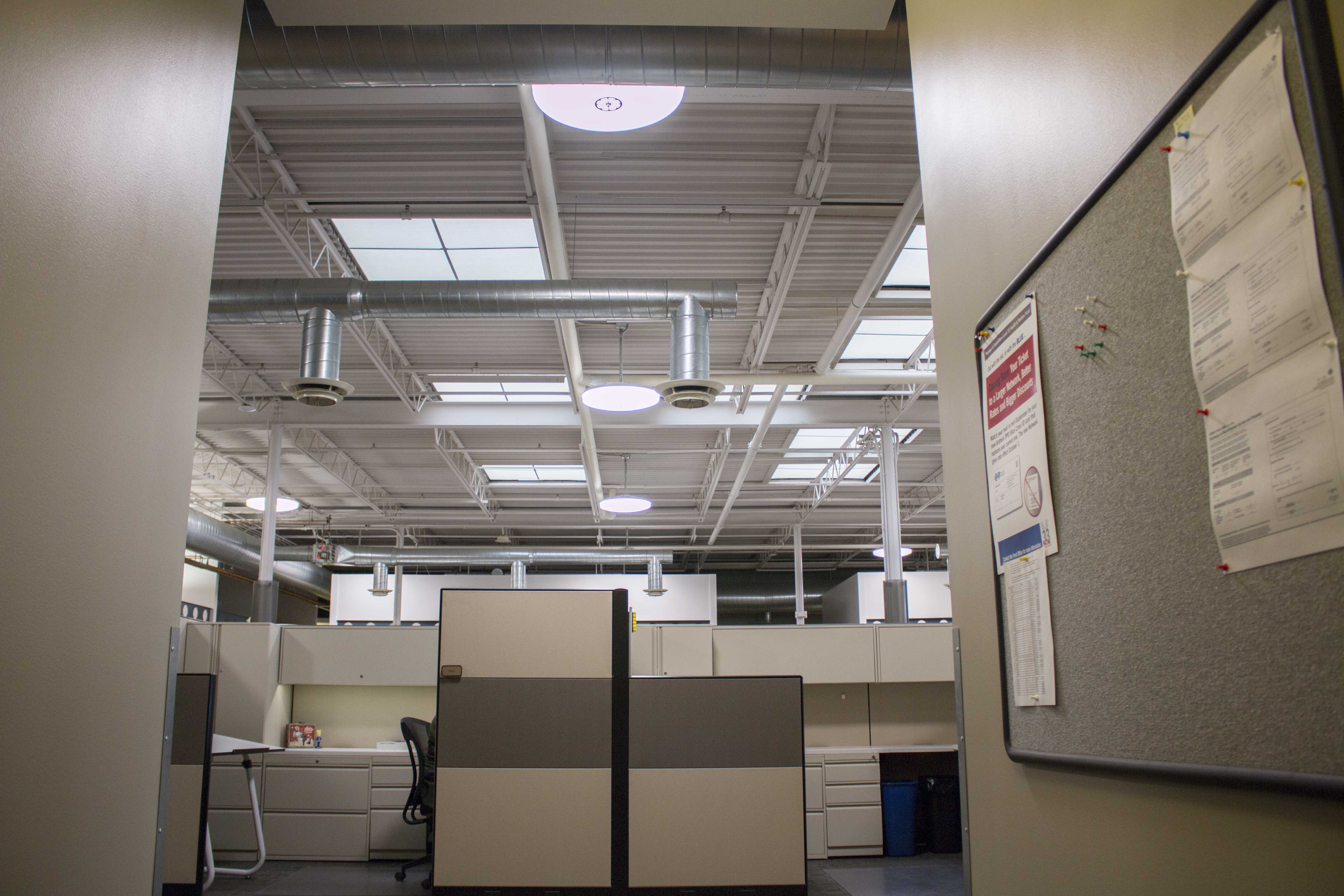 Waldinger office ceiling showing GENISYS PoE pendants and exposed ductwork