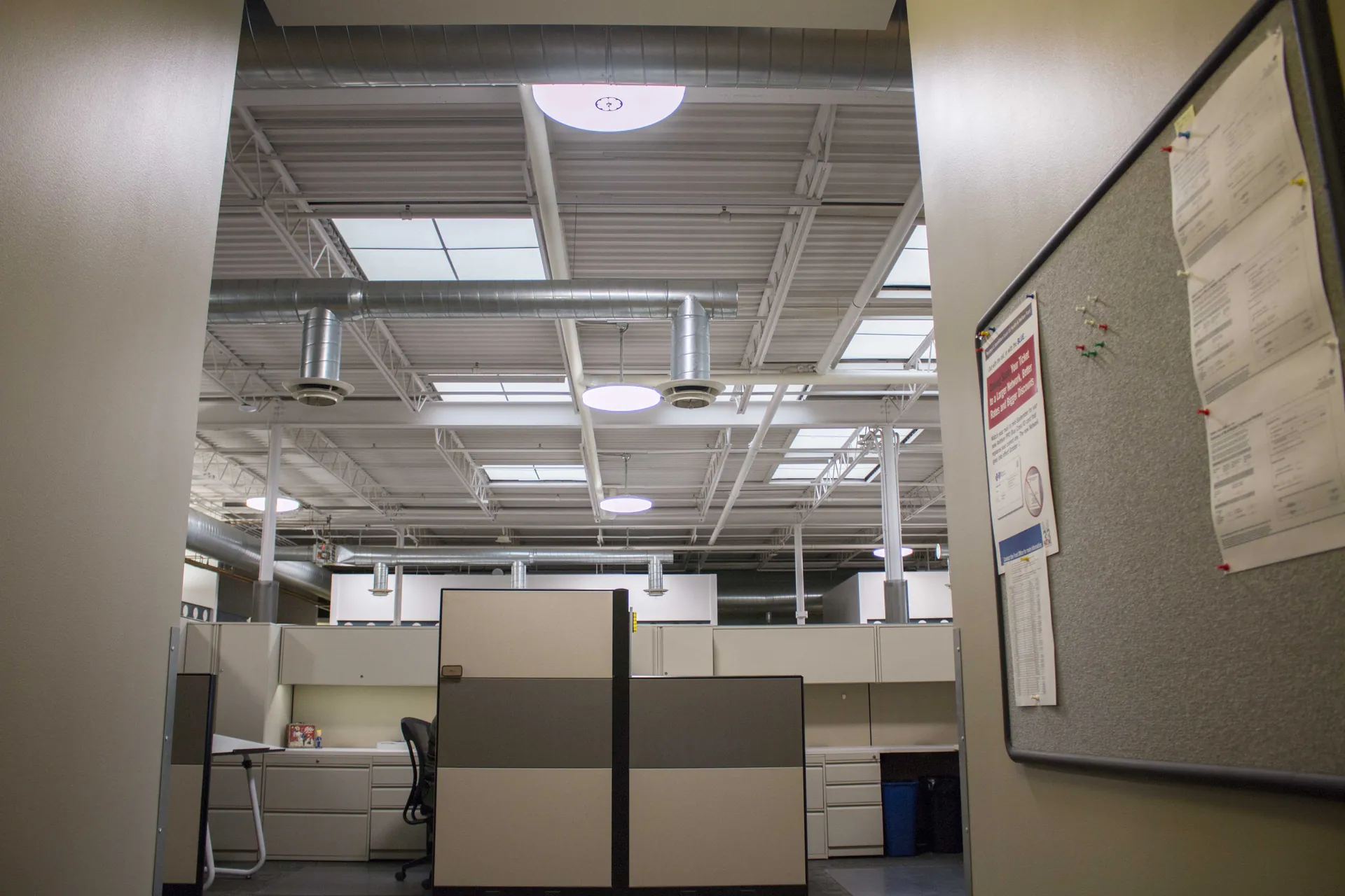 Waldinger office ceiling showing GENISYS PoE pendants and exposed ductwork